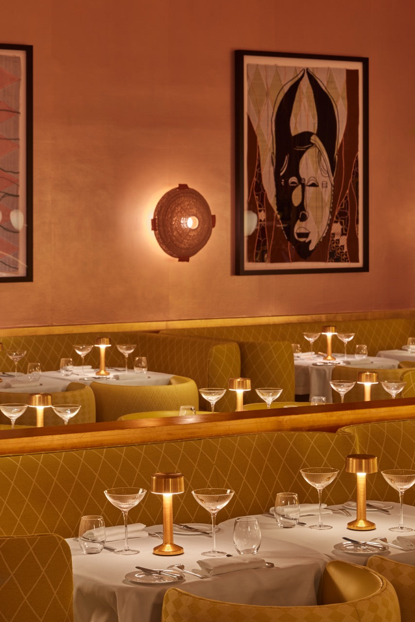 Imagilights lighting setup with rechargeable interior and exterior lamps on café tables illuminating an ambient dining area.