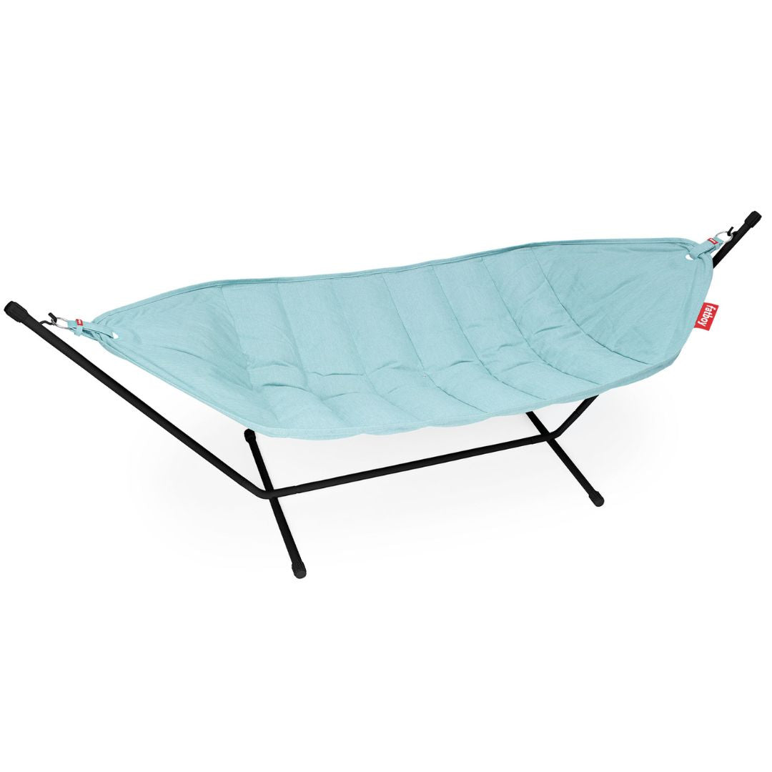 Solid Pacific Blue quilted hammock with matching pillow, mounted on a matte black steel frame by Fatboy, available at Desert River Shop.