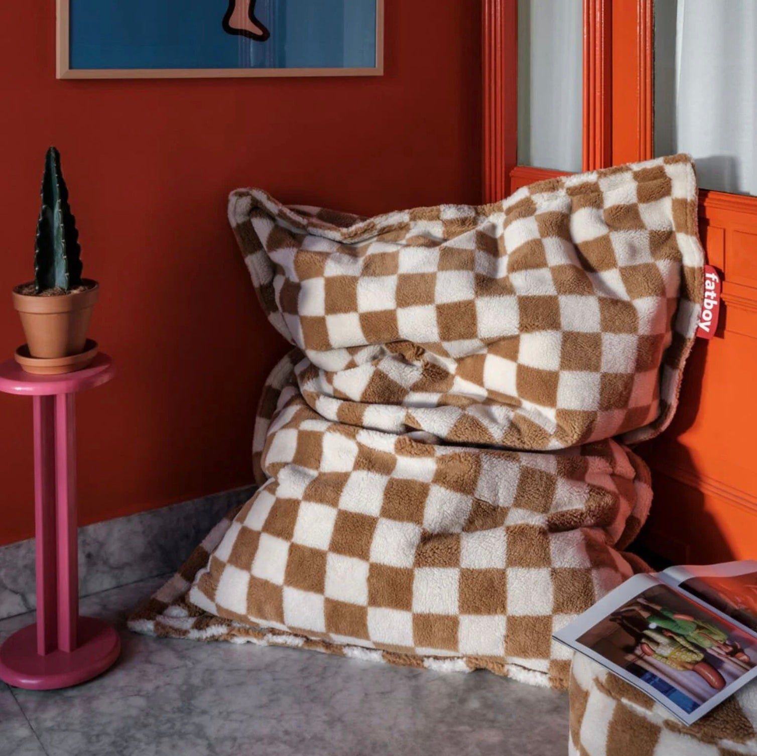 Fatboy Original Slim Teddy Bean Bag in Chess pattern styled in a cosy corner with warm decor tones