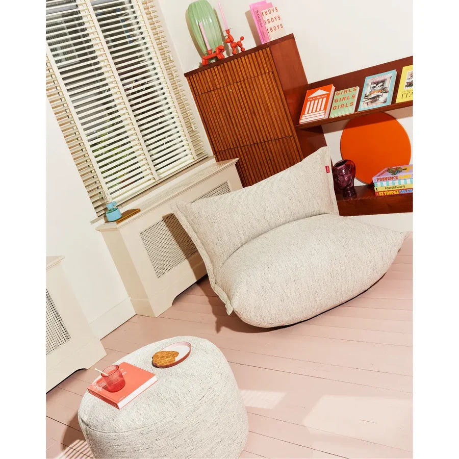 Fatboy Point poufs in velvet fabric styled on a checkered tile patio with round wooden coffee table and natural light
