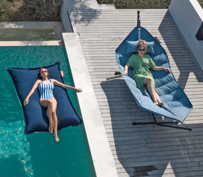 Fatboy Superb Hammock on deck and Original Floatzac floating bean bag in the pool.