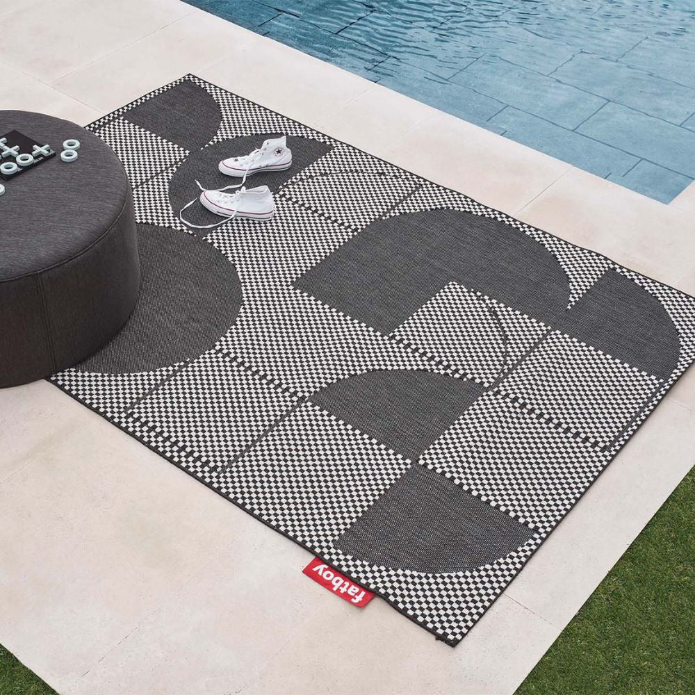 Fatboy Carpretty petit Jigsaw outdoor carpet and rug placed by the pool deck.