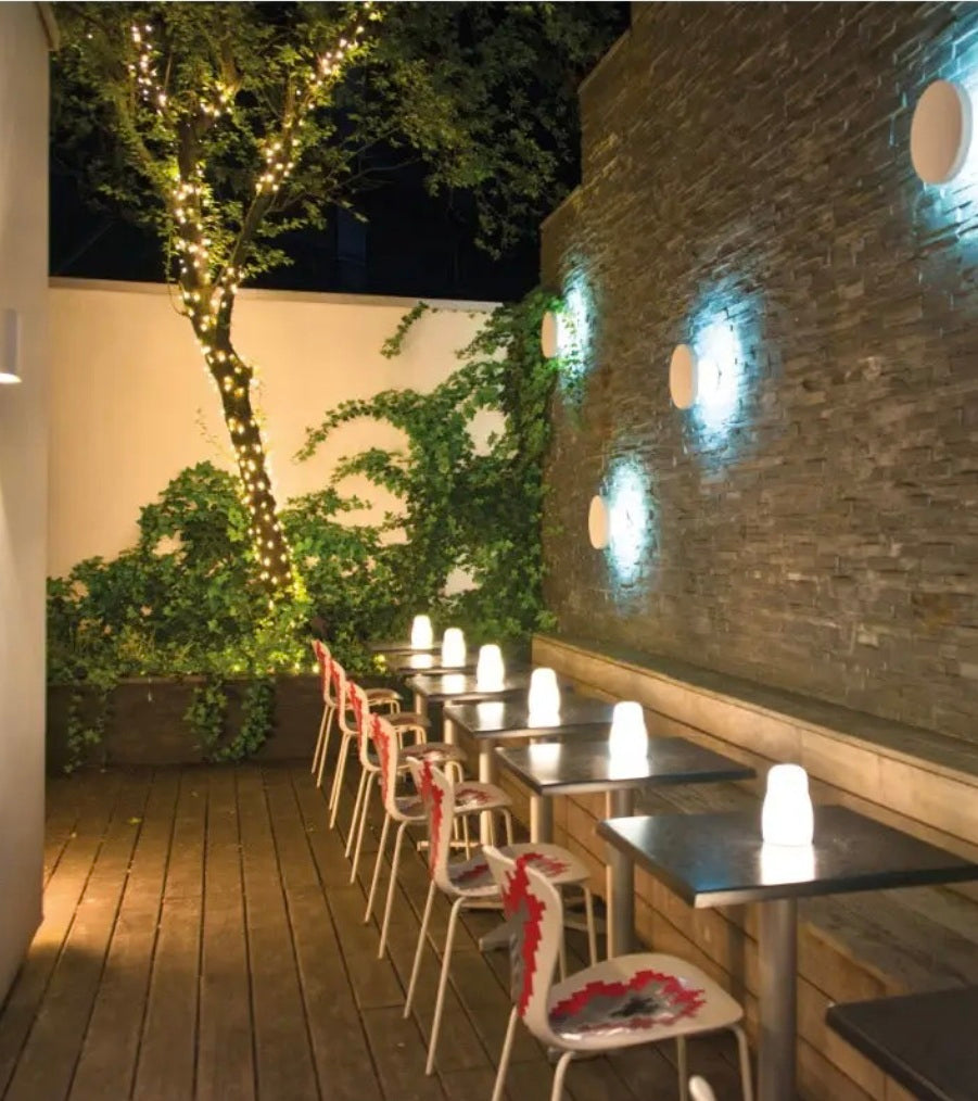 Imagilights outdoor lighting setup featuring the Matroushka table lamps illuminating an ambient dining area.