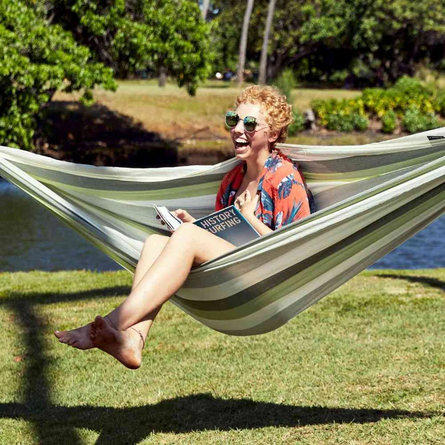 Woman enjoying the LA SIESTA Brisa Hammock Swing during a camping trip.