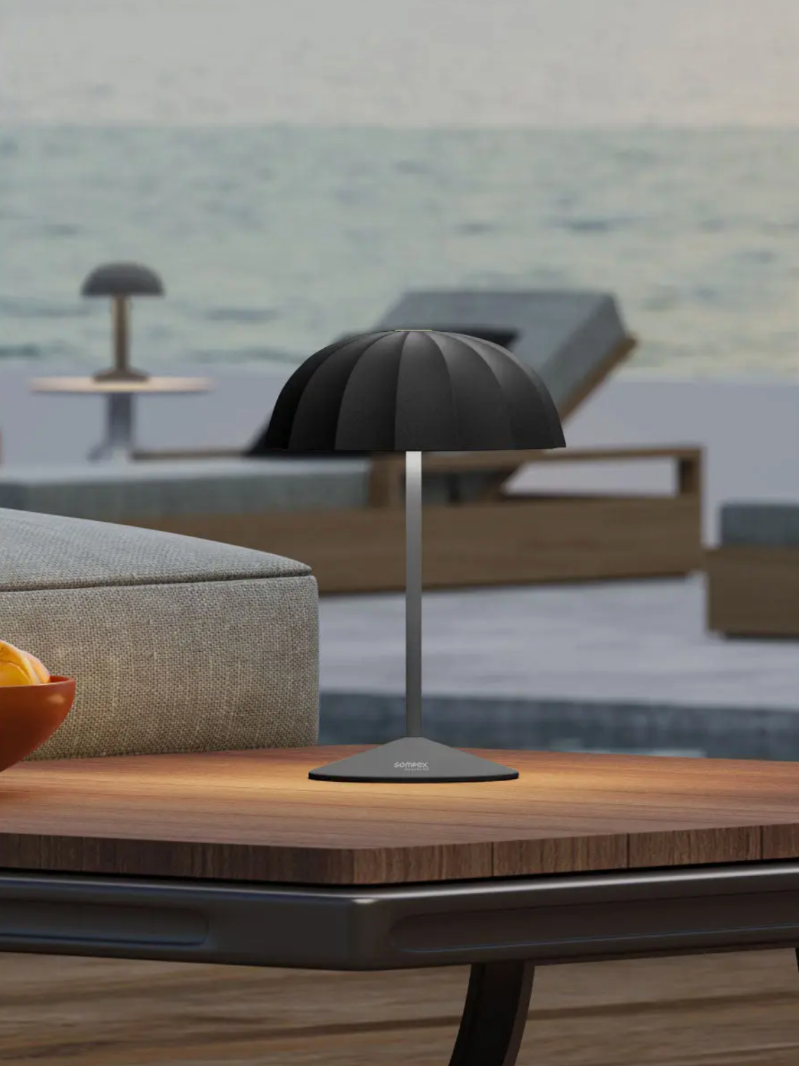 Sompex rechargeable table lamp styled as outdoor lighting on a wooden patio table, ideal for modern garden lights and ambient exterior lamps by the pool.