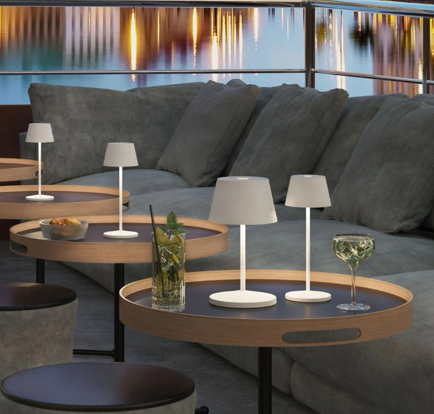 Villeroy & Boch table lamps in matte finish serve as lighting in an al fresco dining area.